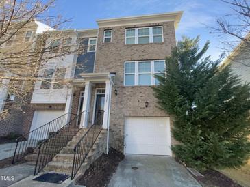 Brick front exterior of charming townhome with attached garage at 5023 Lalex Ln, Cary, NC 27519
