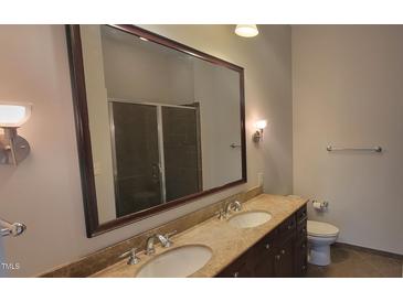 Modern bathroom with double vanity, large mirror, and shower at 618 N Boylan Ave # 1028, Raleigh, NC 27603