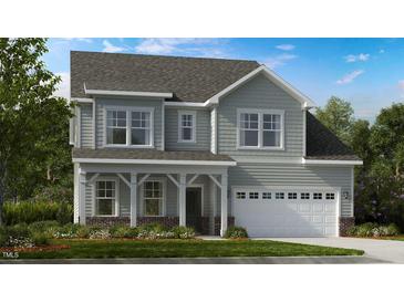 Two-story home with gray siding, white trim, and a covered porch at 661 Morning Glade St, Wake Forest, NC 27587