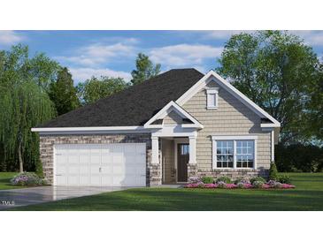 One-story house with stone and shingle accents, two-car garage, and landscaped lawn at 1117 Middlecrest Dr, Rocky Mount, NC 27804