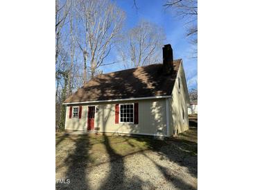 Charming home featuring a brick chimney, red shutters, and a cozy atmosphere at 2324 Lonnie Cir, Hillsborough, NC 27278