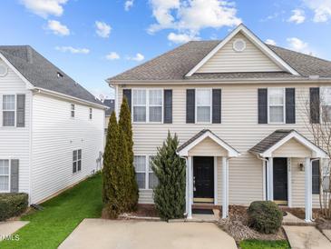 Tan two-story house with black shutters and a tree in the front at 2332 Turtle Point Dr, Raleigh, NC 27604