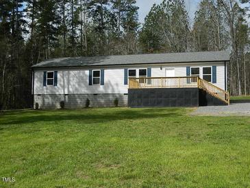 Charming single-story home featuring a lovely front porch and well-maintained lawn and blue shutters at 3050 Bennett Siler City Rd, Bennett, NC 27208