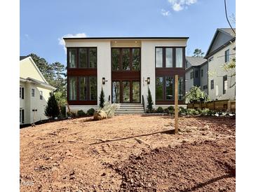 Modern two-story home with large windows and a brick facade, awaiting landscaping at 3315 Hampton Rd, Raleigh, NC 27607