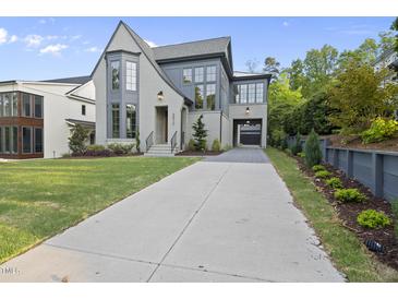 Stunning two-story home features a modern gray exterior, manicured lawn, and an inviting driveway at 3317 Hampton Rd, Raleigh, NC 27607