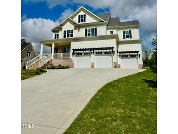 Inviting exterior of a white two-story home with a three car garage and a concrete driveway at 1229 Azalea Garden Cir, Raleigh, NC 27603
