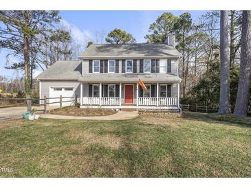 Two-story house with gray siding, red door, and attached garage at 4224 Sancroft Dr, Apex, NC 27539