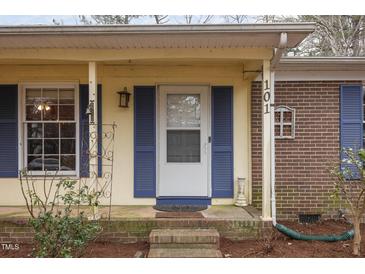 Inviting front porch with blue shutters and brick steps at 101 Monterey Ln, Durham, NC 27713