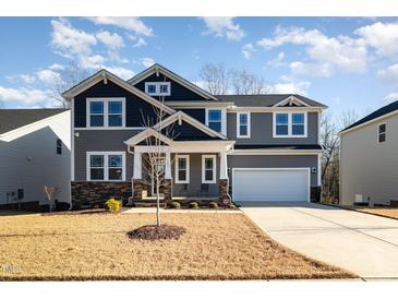 Two-story home with gray siding, stone accents, and a two-car garage at 105 Scoville Rd, Garner, NC 27529