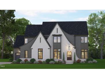 Two-story home with gray and white brick exterior, large windows and landscaped lawn at 109 Evander Way, Pittsboro, NC 27312