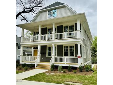 Charming two-story home with a double front porch, white railings, and a well-manicured lawn at 1300 Broad St # A, Durham, NC 27705