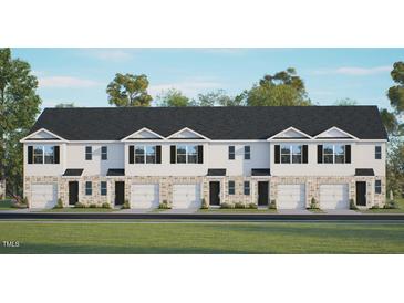 Three-story townhome building with attached garages and lawn at 313 Cherry Laurel Dr, Sanford, NC 27332