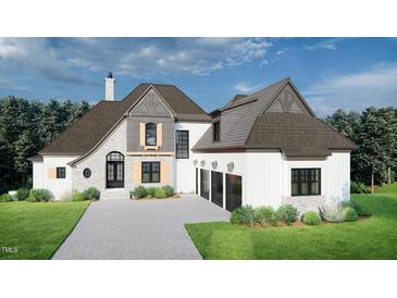 Beautiful two-story home showcasing stone and siding accents, complemented by a three-car garage and lush landscaping at 64 Barn Owl, Pittsboro, NC 27312
