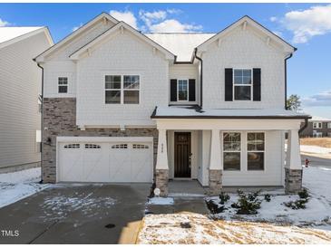 Two-story house with white siding, stone accents, and a two-car garage at 800 Summit Crest Ct, Apex, NC 27523