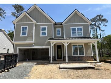 Newly constructed two-story home showcasing a covered entrance and attached two-car garage at 1105 Opal Ln # 70, Durham, NC 27705