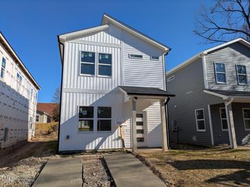 Two-story house with white siding, a covered entry, and a small front yard at 111 S Plum St, Durham, NC 27703