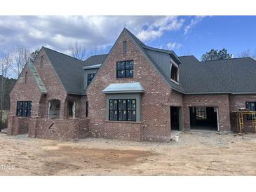 Brick exterior showcasing classic design elements and large windows at 274 Westhampton Dr, Pittsboro, NC 27312