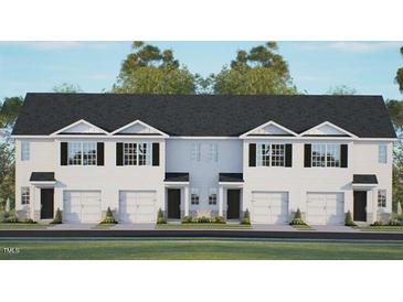 Three-unit townhome building with attached garages and landscaping at 315 Cherry Laurel Dr, Sanford, NC 27332