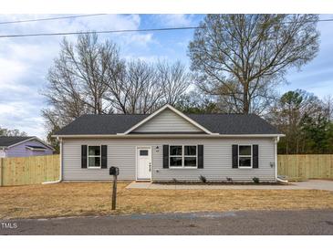 Charming single-story home with grey siding, black shutters, and a well-manicured front yard at 420 E Cedar Ave, Wake Forest, NC 27587