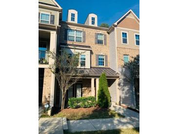 Brick front exterior of charming townhome with landscaping at 4972 Highcroft Dr, Cary, NC 27519