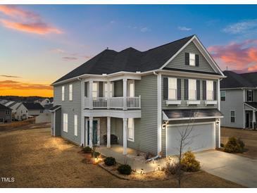 Two-story house with gray siding, balcony, and attached garage at 655 Hawksbill Dr, Franklinton, NC 27525
