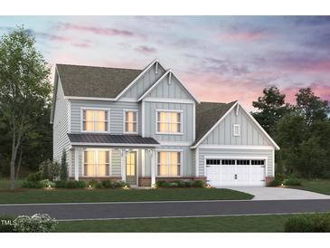 Two-story house with light gray siding, a metal roof, and a two-car garage at 1108 Opal Ln # 103, Durham, NC 27705