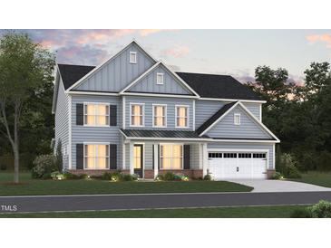 Two-story house with gray siding, a white garage door, and landscaping at 1112 Opal Ln # 102, Durham, NC 27705