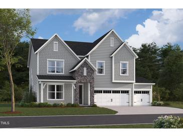 Two-story house with gray siding, stone accents, and a three-car garage at 1117 Opal Ln # 73, Durham, NC 27705
