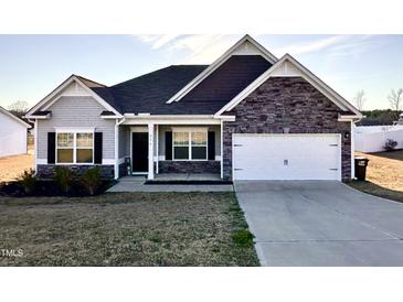 Charming single-Gathering home with a manicured lawn and attached two-car garage at 256 Barbour Farm Ln, Four Oaks, NC 27524