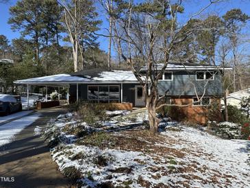 Snow covered ranch home with covered carport and mature landscaping at 3501 Swift Dr, Raleigh, NC 27606