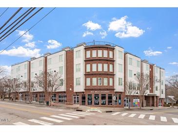 Modern three-story building with brick accents and street-level retail at 400 W Rosemary St # 405, Chapel Hill, NC 27516