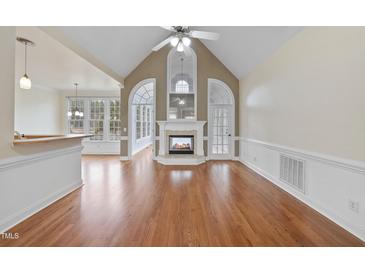 Bright living room features a fireplace, hardwood floors, and ample natural light at 701 Occoneechee Dr, Fuquay Varina, NC 27526