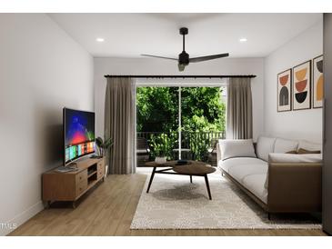 Bright living room featuring modern furniture and access to a balcony at 711 E Lenoir St # 205, Raleigh, NC 27601