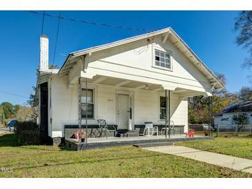 Charming one-story home with a covered porch and well-maintained lawn at 1026 Nashville Rd, Rocky Mount, NC 27803