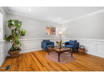 Bright living room with hardwood floors and stylish seating at 124 W Cornwallis Rd, Durham, NC 27707