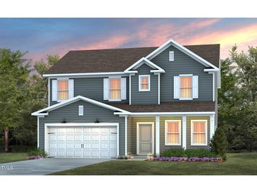 Two-story house with gray siding, white garage door, and landscaping at 1404 Hollyview Ave, Durham, NC 27703