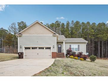 Ranch style home with two car garage and brick accents at 165 Turlington Rd, Dunn, NC 28334
