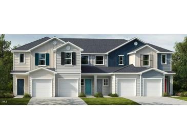 Three-unit townhome building with modern exterior finishes and two-car garages at 1997 Rabbitbrush St, Durham, NC 27703