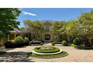 Stately two-story home with manicured landscaping and circular driveway at 32602 Archdale, Chapel Hill, NC 27517