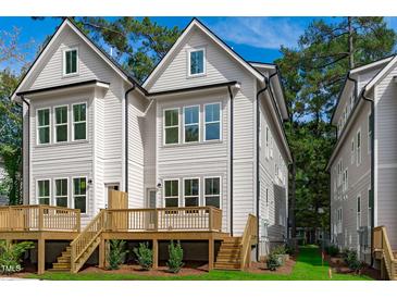Beautiful backyard deck with wooden stairs and lush green landscaping for outdoor enjoyment at 5041 Lundy Dr # 101, Raleigh, NC 27606