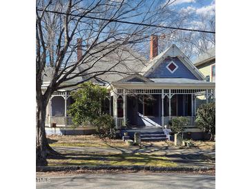 Charming Victorian home featuring a wraparound porch and well-manicured lawn at 517 N East St, Raleigh, NC 27604