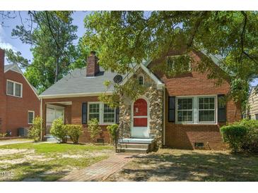 Charming brick home with stone accents, black shutters, and a well-maintained front yard at 945 Sycamore St, Rocky Mount, NC 27801