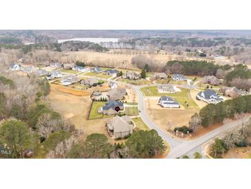 Beautiful aerial view of a neighborhood with large homes near a lake at 101 Bonica Creek Dr, Garner, NC 27529