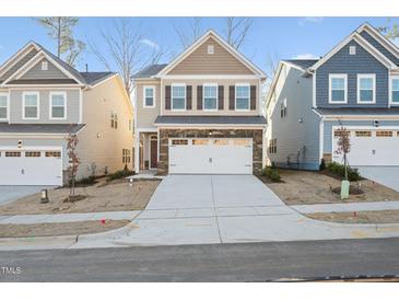 Two-story home with neutral siding and a two-car garage at 501 Hanover Shore Ln, Raleigh, NC 27610