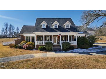 Brick home with wraparound porch, showcasing a classic design at 5765 G Snow Camp Rd, Graham, NC 27253