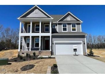 Beautiful two story home with a two-car garage, covered porch and gray siding at 85 N Stagecoach Dr, Wendell, NC 27591