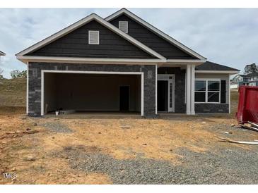 New construction home featuring a stone facade, attached garage, and contemporary design at 121 Northwood Dr, Fuquay Varina, NC 27526
