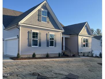 Two-story home with gray siding, attached garage, and landscaped yard at 15 Long Needle Ct # 38, Youngsville, NC 27596