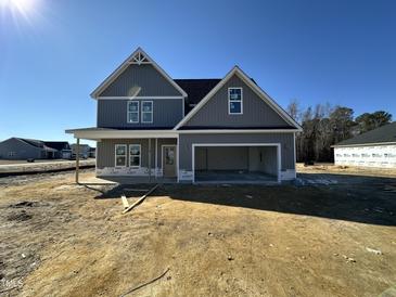 Two-story house with gray siding, attached garage, and covered porch at 15 Lupin Dr, Smithfield, NC 27577