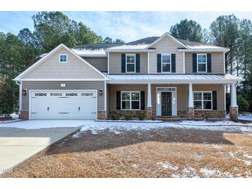 Two-story house with gray siding, white trim, and a covered porch at 157 Winston Pointe Dr, Clayton, NC 27520